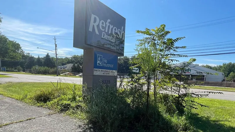 Overgrown commercial grounds before property maintenance in Northeast Ohio