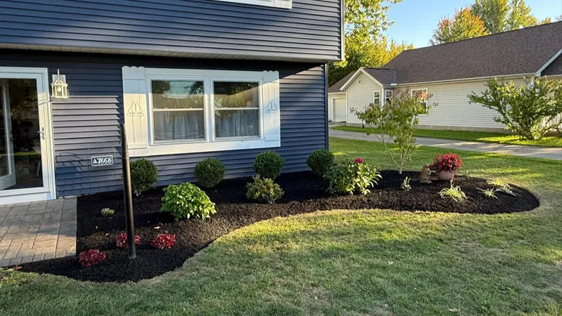 Finished front garden bed renovation with new shrubs and plants in Northeast Ohio