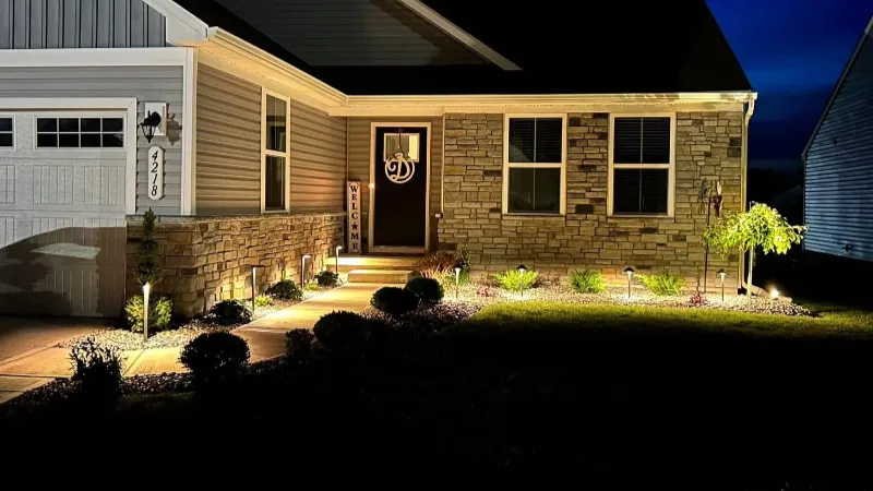 Residential landscaping illuminated with professional outdoor lighting in Mentor Ohio