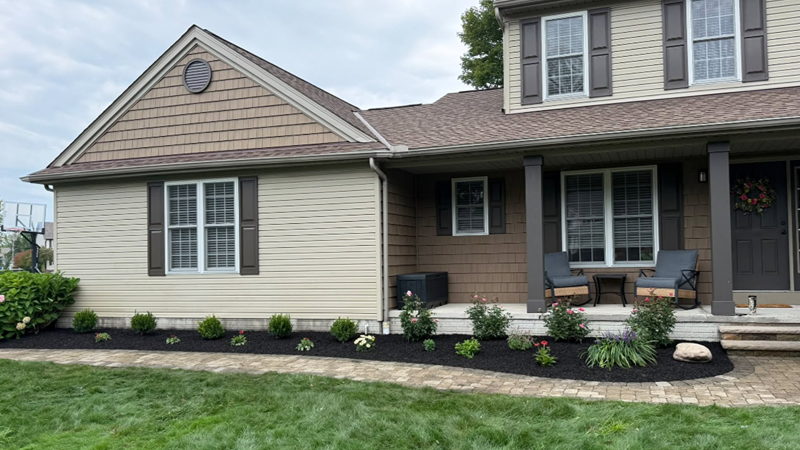 Custom landscape design with trees shrubs and garden beds in Northeast Ohio